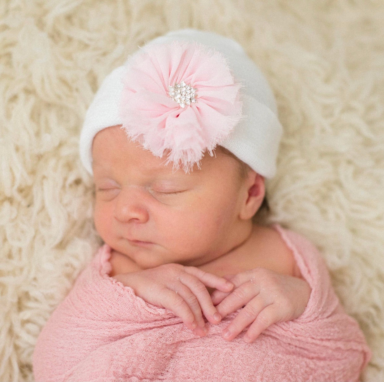 White newborn hospital hat with pink frayed flower
