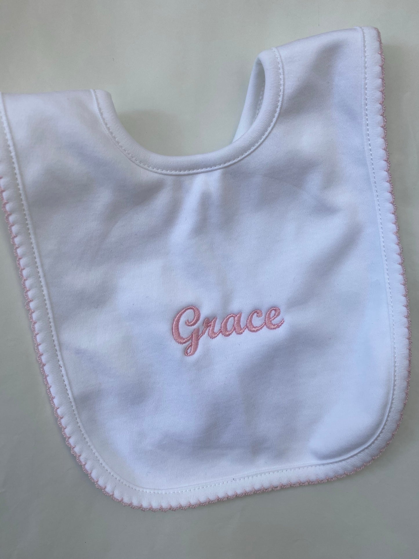 White with pink trim pima cotton bib