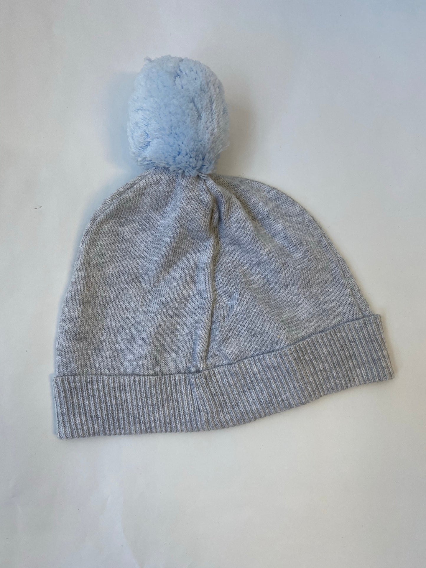 Knit beanie with blue pom pom