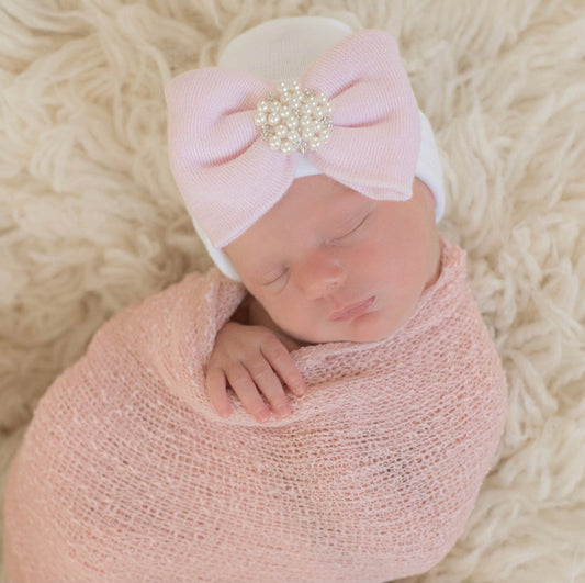 White newborn beanie hat with pink bow and Pearl cluster center