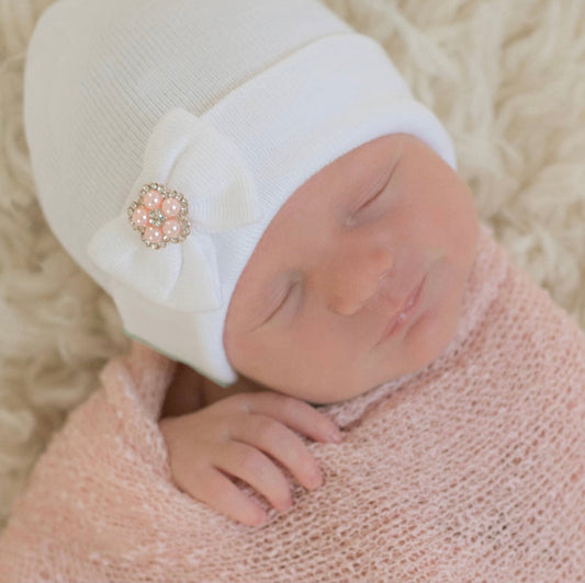 White newborn hospital hat with tiny bow detail