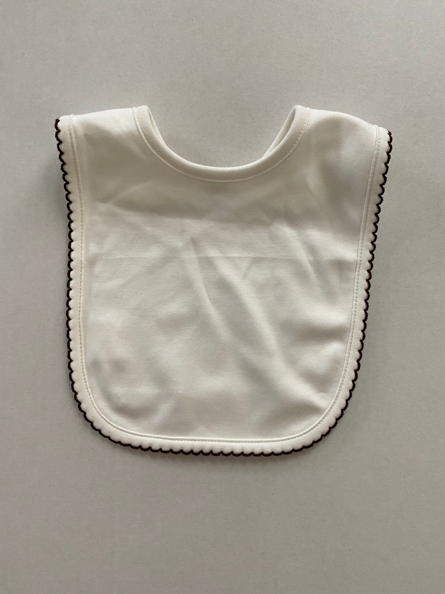 Cream pima cotton bib with chocolate trim