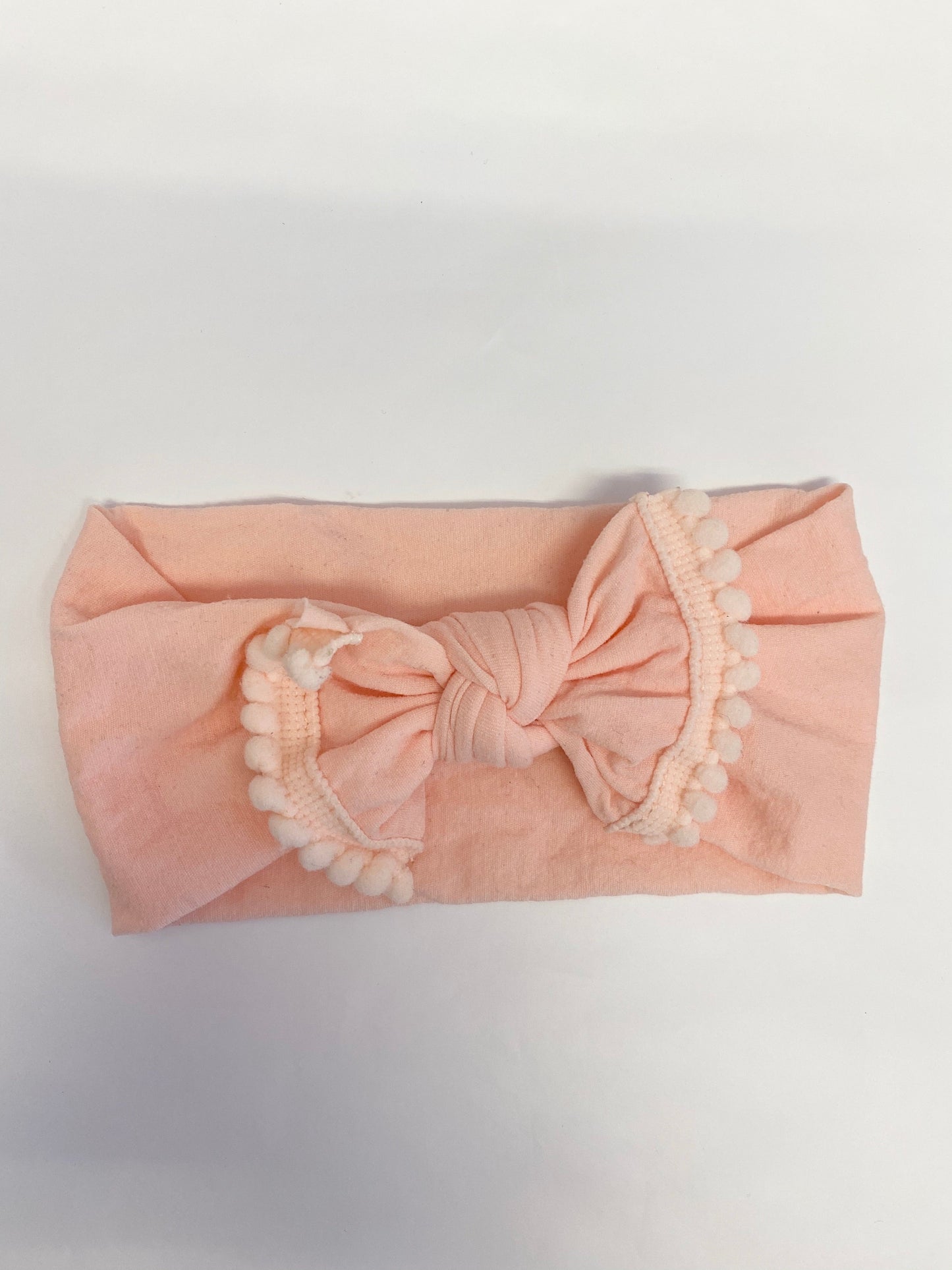Peach nylon headband with pom pom bow